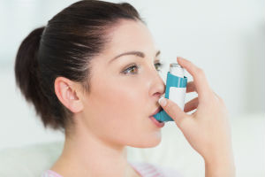 woman-using-inhaler