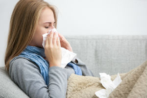 woman-with-flu-using-tissue