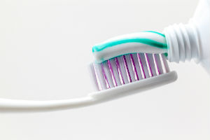 toothpaste-being-placed-on-toothbrush