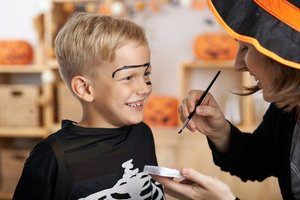 A boy getting his face painted. Some Halloween makeup kits may contain unsafe ingredients that can be toxic.