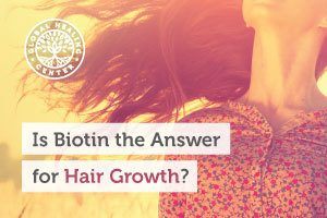 A woman with long healthy hair. Biotin might play a role in hair growth.