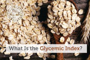 A wooden spoon full of oats. Foods like hummus, carrots, quinoa, and oats are ranked low in the glycemic index food chart.
