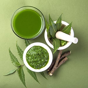 A glass of neem tea. Skin care is one of many benefits of neem.