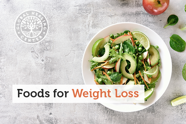 A bowl of salad that contains several weight loss foods like carrots and avocados.